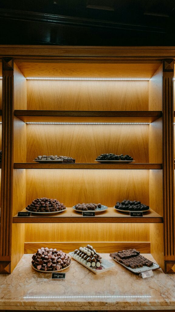 Luxe chocolate assortment on elegant wooden shelves in İstanbul.