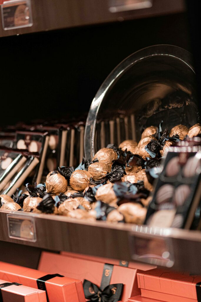 Close-up of assorted chocolates elegantly arranged on a store shelf, showcasing their rich design.
